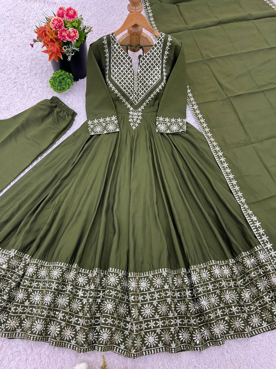 Green mirror-work kurti with silver embroidery, flared sharara pants, and coordinated embroidered dupatta.