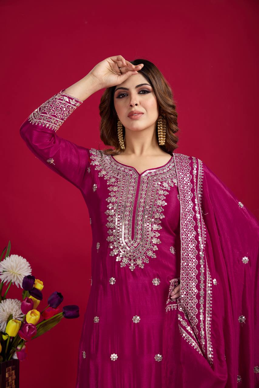 Magenta mirror-work kurti with silver embroidery, flared sharara pants, and coordinated embroidered dupatta.