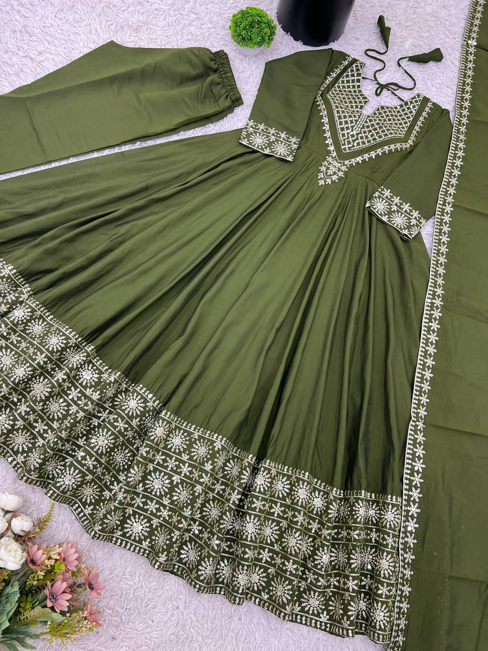 Green mirror-work kurti with silver embroidery, flared sharara pants, and coordinated embroidered dupatta.