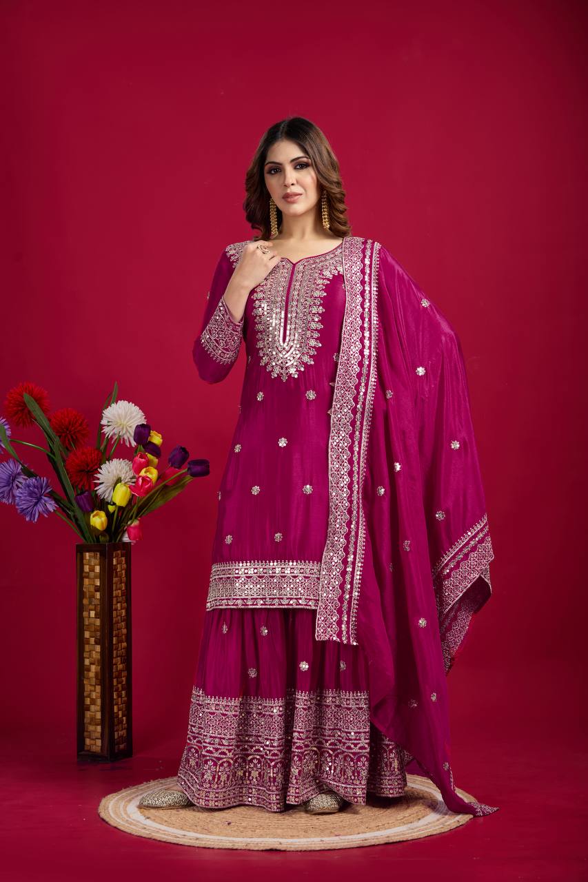 Magenta mirror-work kurti with silver embroidery, flared sharara pants, and coordinated embroidered dupatta.