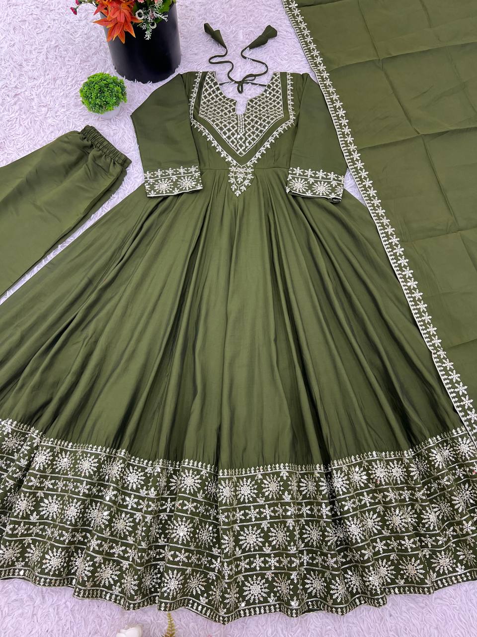 Green mirror-work kurti with silver embroidery, flared sharara pants, and coordinated embroidered dupatta.