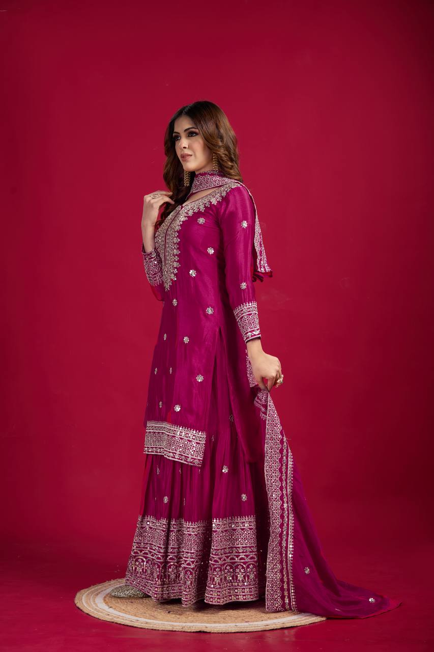 Magenta mirror-work kurti with silver embroidery, flared sharara pants, and coordinated embroidered dupatta.