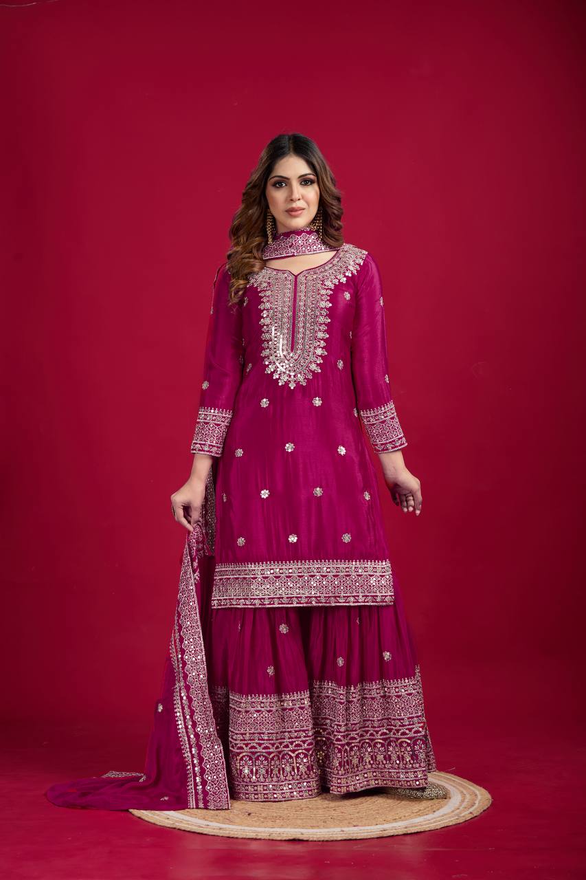 Magenta mirror-work kurti with silver embroidery, flared sharara pants, and coordinated embroidered dupatta.