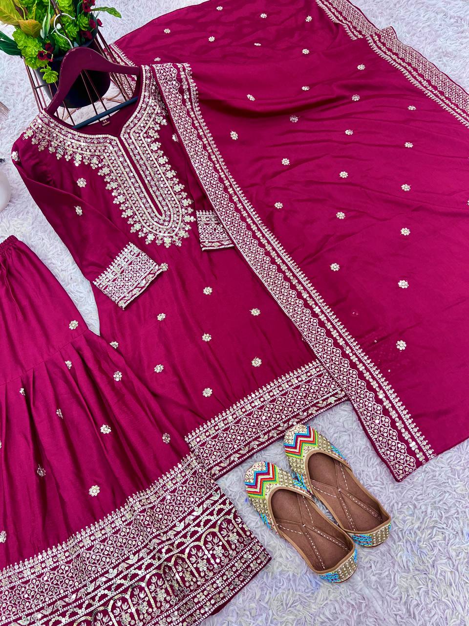 Magenta mirror-work kurti with silver embroidery, flared sharara pants, and coordinated embroidered dupatta.