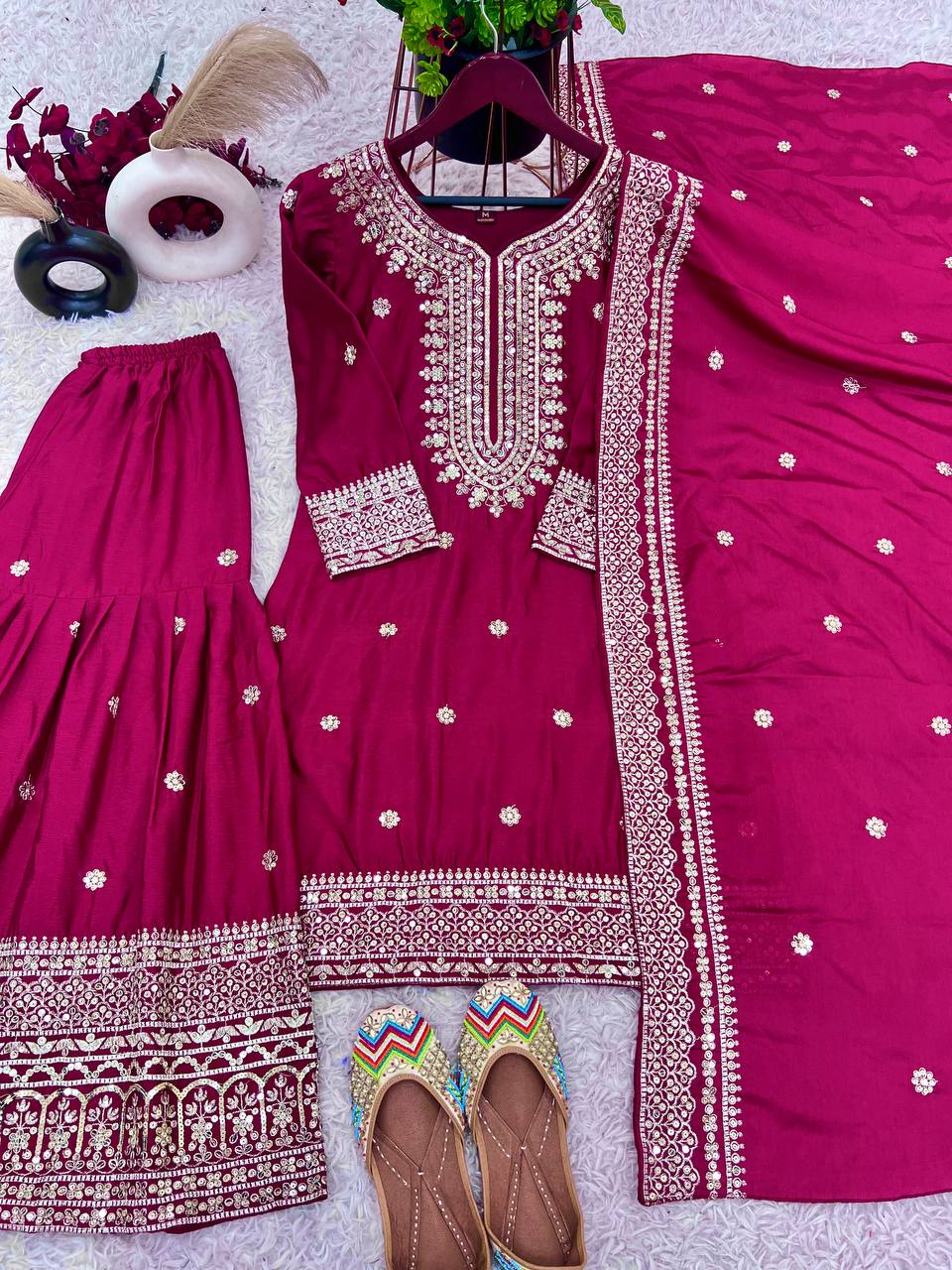 Magenta mirror-work kurti with silver embroidery, flared sharara pants, and coordinated embroidered dupatta.