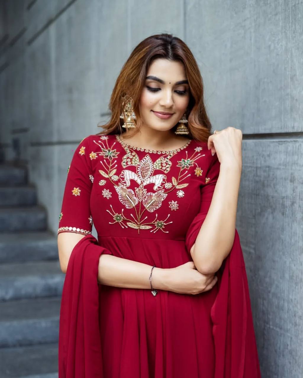 Maroon georgette embroidered high-low kurti paired with straight pants and a matching draped dupatta