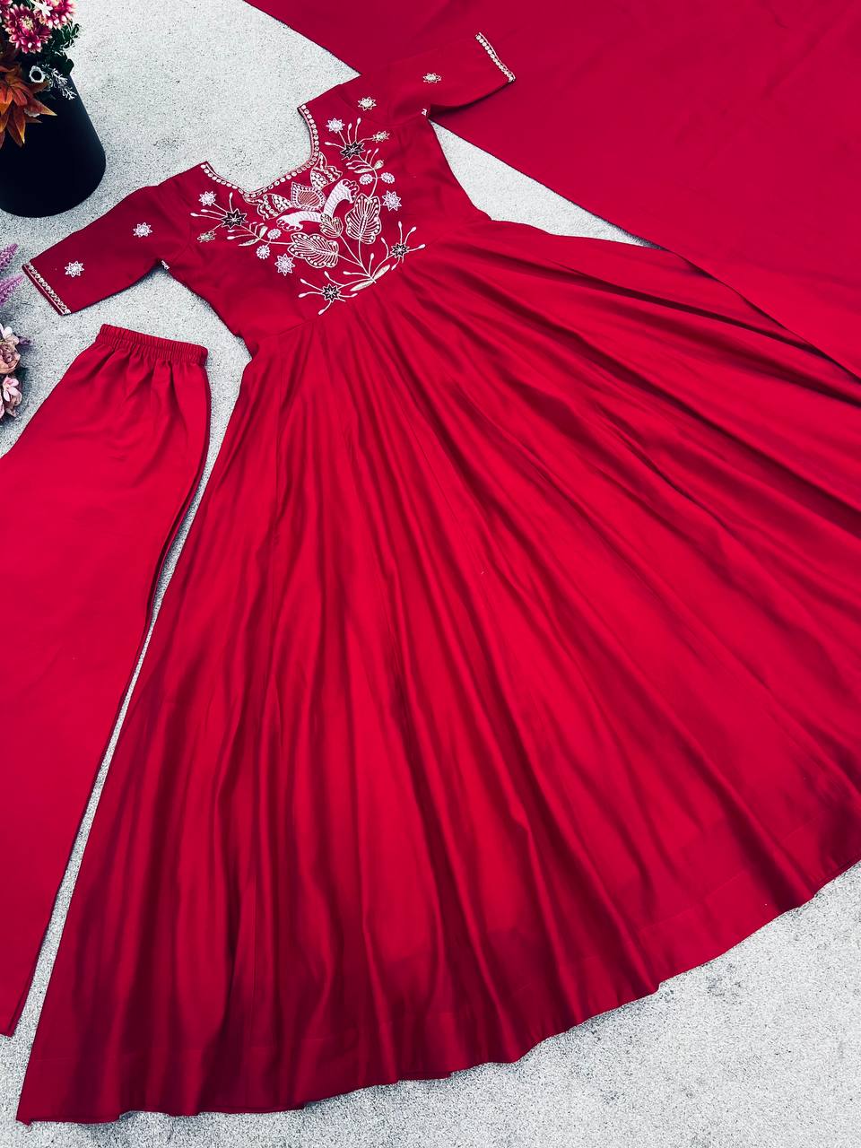 Maroon georgette embroidered high-low kurti paired with straight pants and a matching draped dupatta