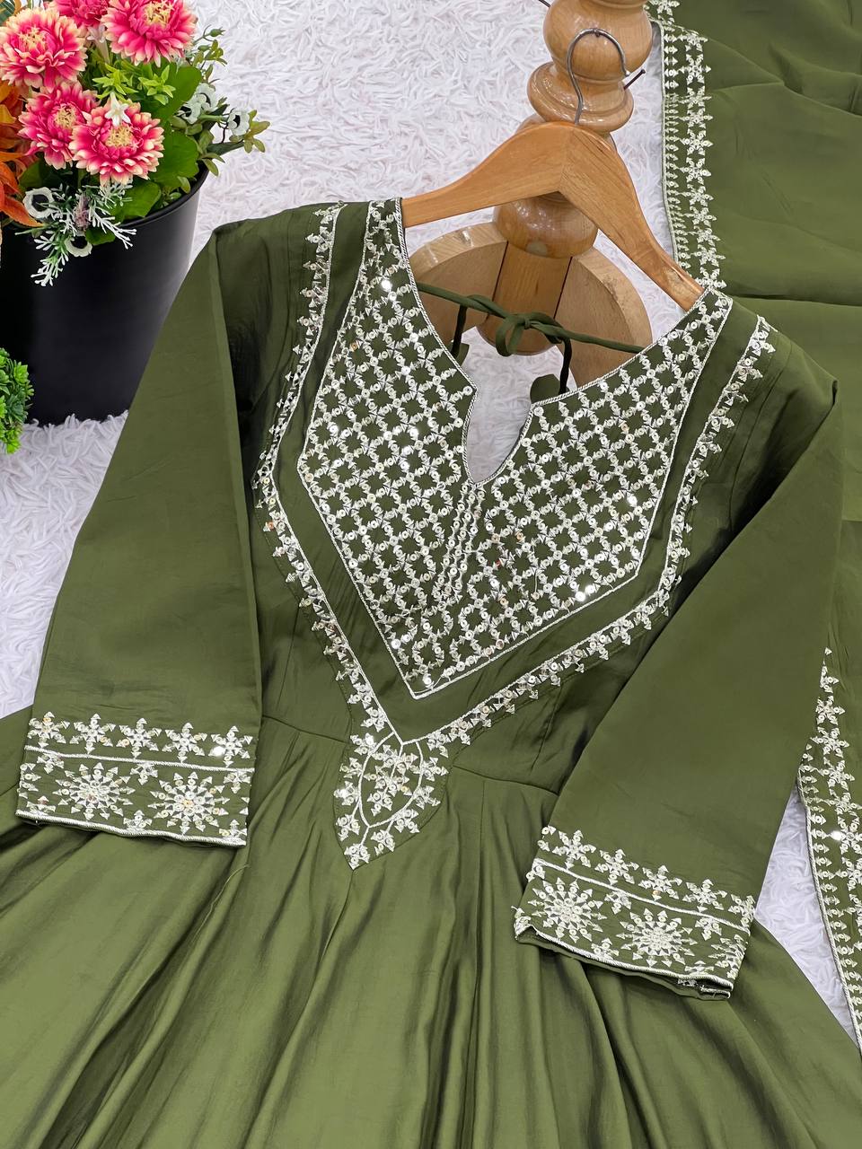 Green mirror-work kurti with silver embroidery, flared sharara pants, and coordinated embroidered dupatta.